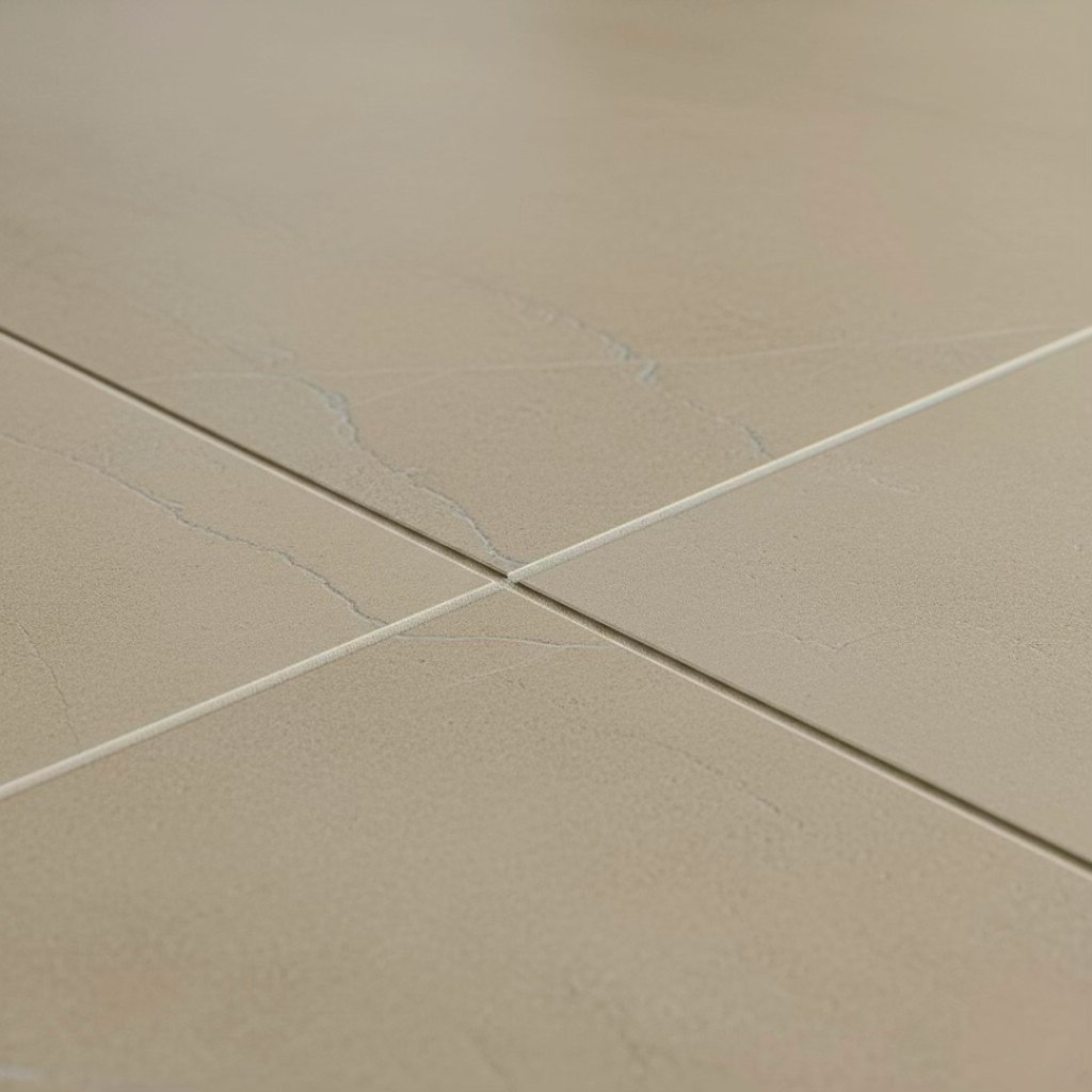 Close-up view of a modern, light-colored tile flooring featuring subtle texture and vein patterns.