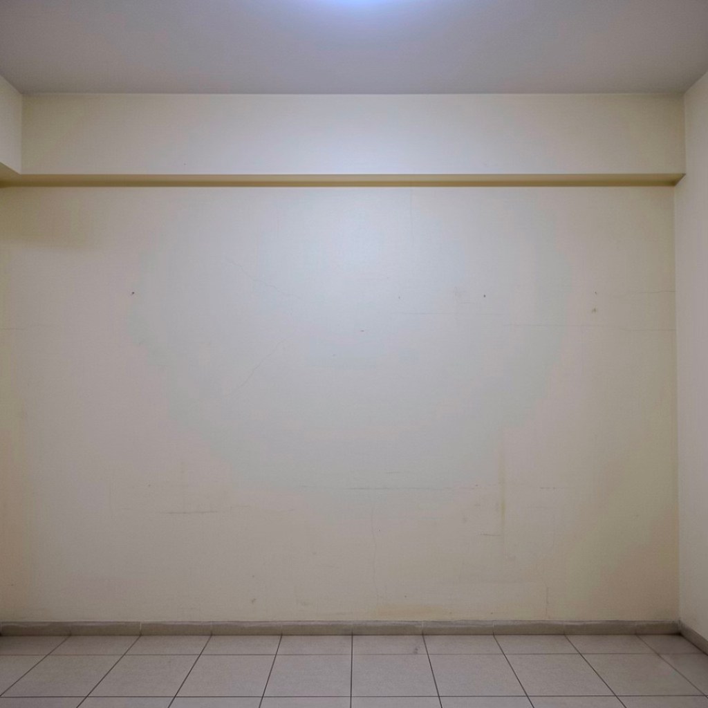 A plain, lightly colored wall with visible imperfections, such as scuffs and scratches, accompanied by tiled flooring in a condo setting.